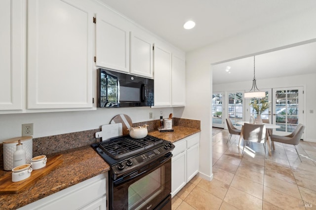 kitchen featuring white cabinets, dark stone countertops, and black appliances