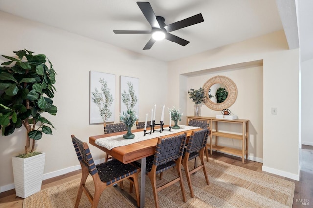 dining area featuring wood-type flooring and ceiling fan