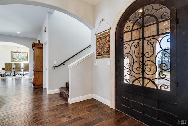 entrance foyer featuring hardwood / wood-style floors and a chandelier