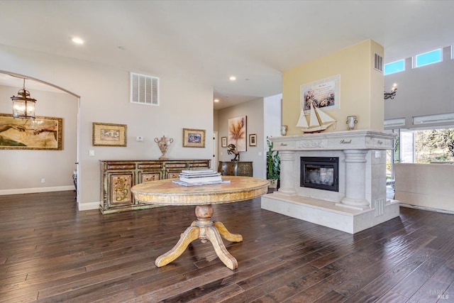 living room with a premium fireplace and dark hardwood / wood-style floors