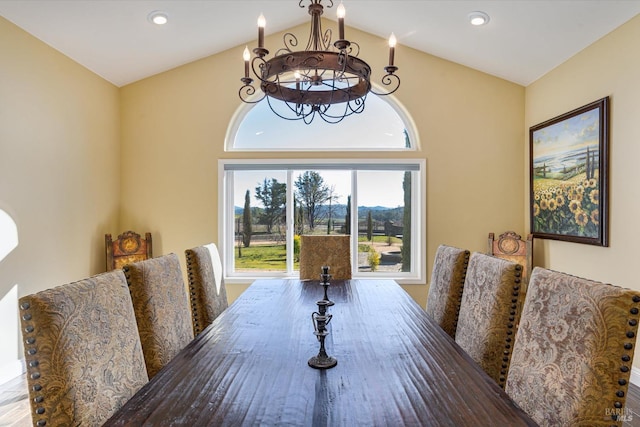 dining area with vaulted ceiling and a notable chandelier