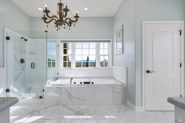 bathroom featuring an inviting chandelier and separate shower and tub