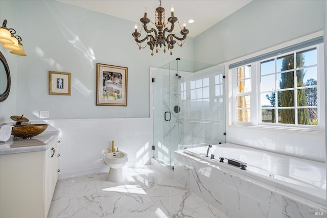 bathroom featuring vanity, a chandelier, independent shower and bath, and a bidet