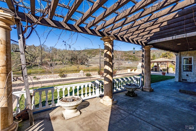 view of patio with a gazebo, a mountain view, and a pergola