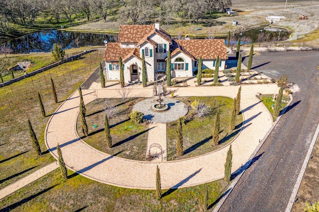 birds eye view of property with a water view