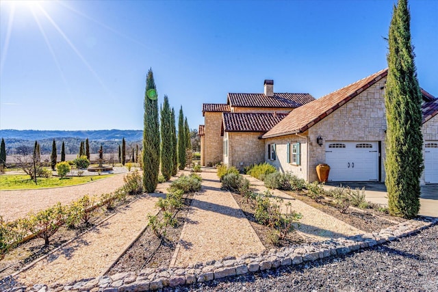 view of front of house with a mountain view and a garage