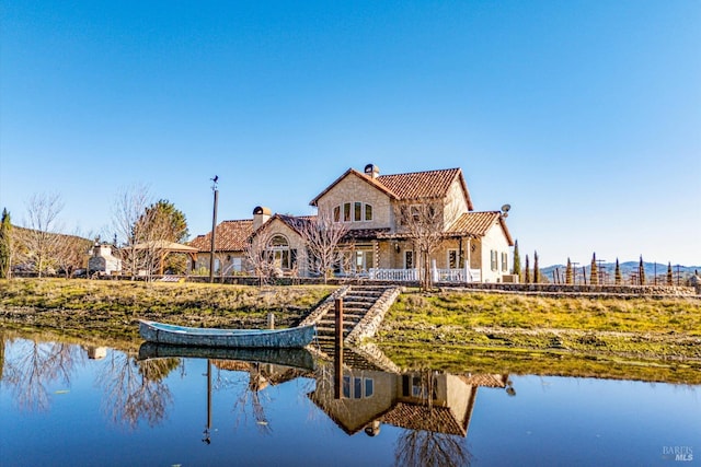 rear view of property with a water view