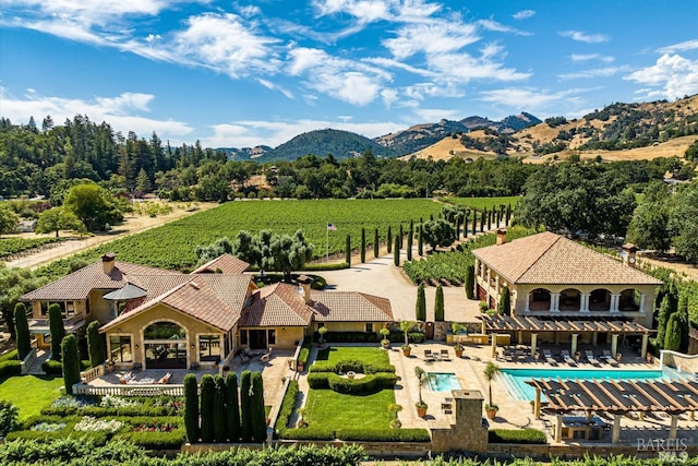 drone / aerial view featuring a mountain view and a rural view