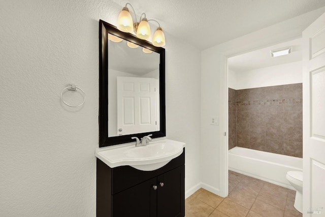 full bathroom featuring tile patterned flooring, vanity, tiled shower / bath, and toilet