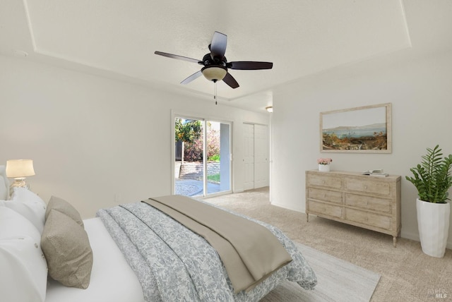 carpeted bedroom featuring access to outside and ceiling fan