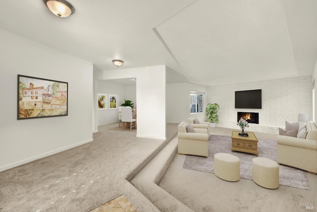 carpeted living room with a brick fireplace