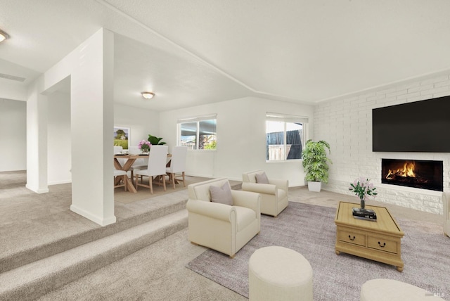 living room featuring carpet flooring and a fireplace