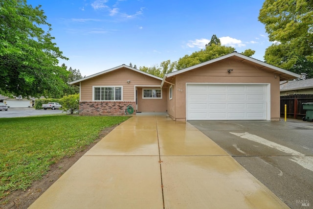 ranch-style house with a garage and a front yard