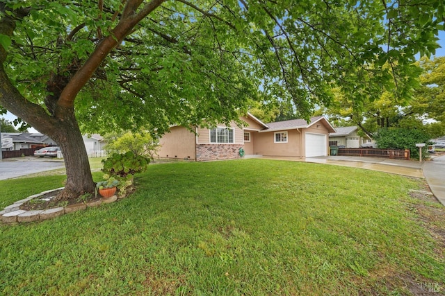 single story home featuring a garage and a front yard