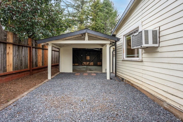 view of parking featuring gravel driveway and fence