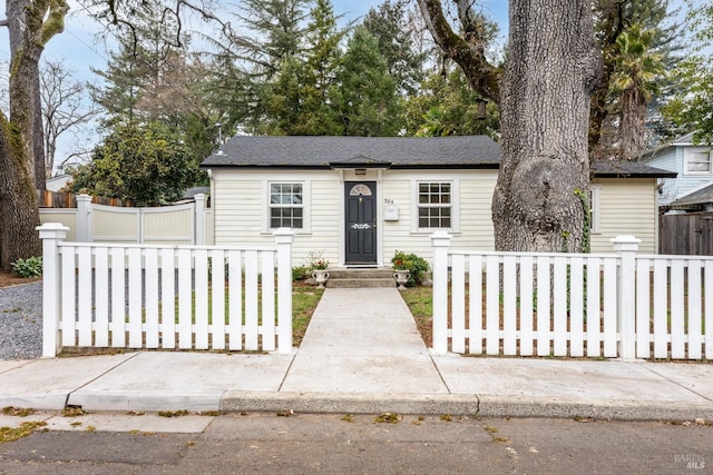 view of front of house featuring entry steps and fence