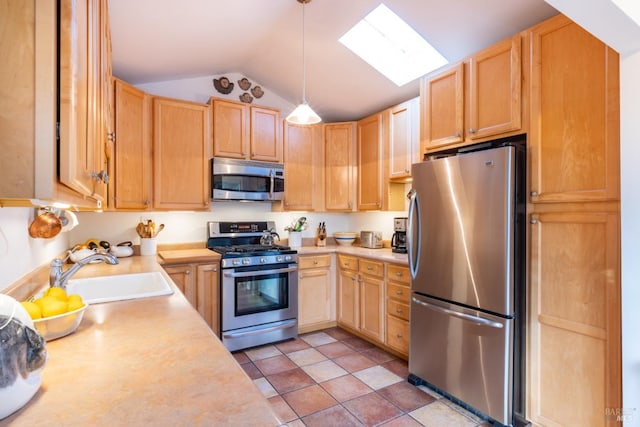 kitchen with sink, stainless steel appliances, vaulted ceiling with skylight, decorative light fixtures, and light brown cabinets