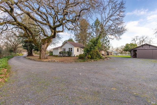 view of side of home with an outdoor structure