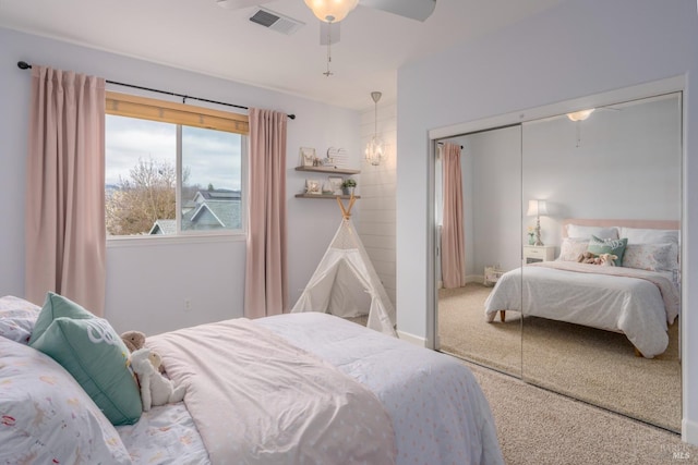 carpeted bedroom with a closet and ceiling fan