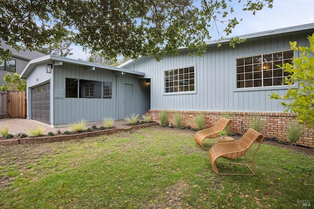 ranch-style house with a garage and a front lawn