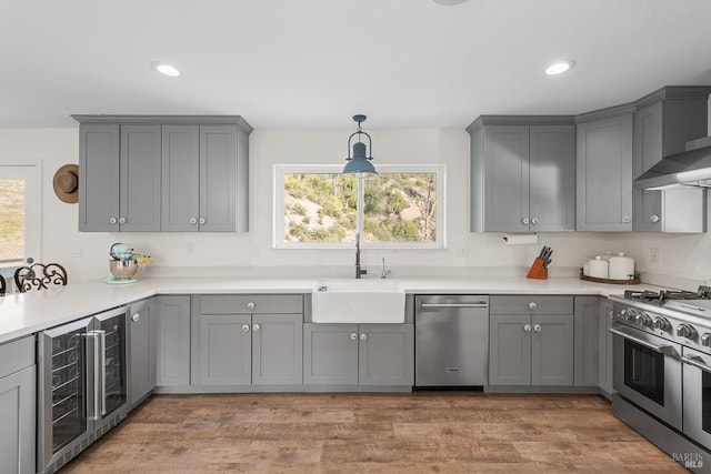 kitchen featuring stainless steel appliances, wine cooler, gray cabinets, and light countertops