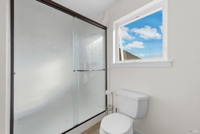 full bathroom with an enclosed shower and toilet