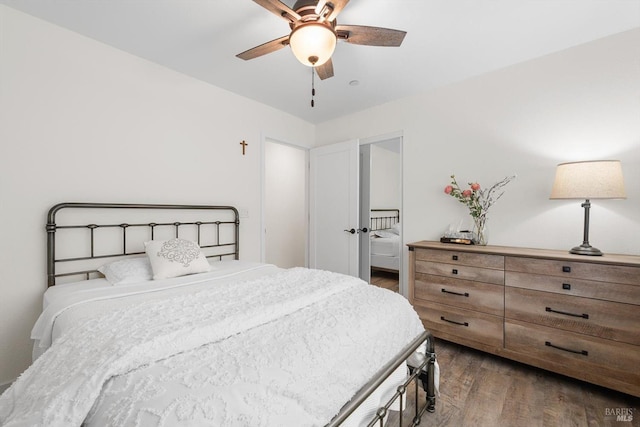 bedroom with dark wood-type flooring and a ceiling fan