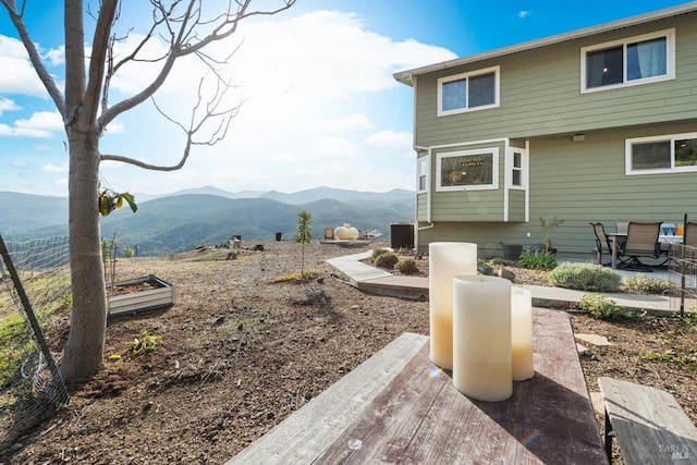 exterior space featuring a mountain view and a patio