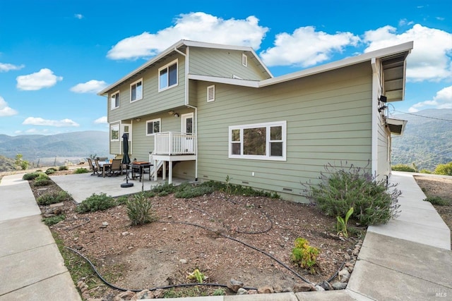 rear view of property with a patio area and a mountain view