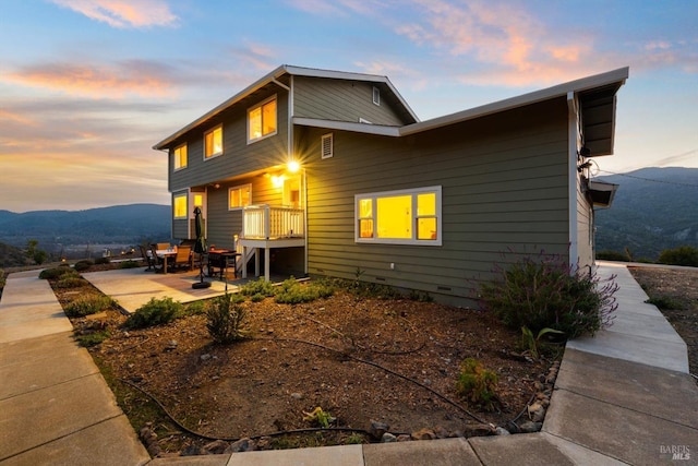 exterior space with a patio area and a mountain view