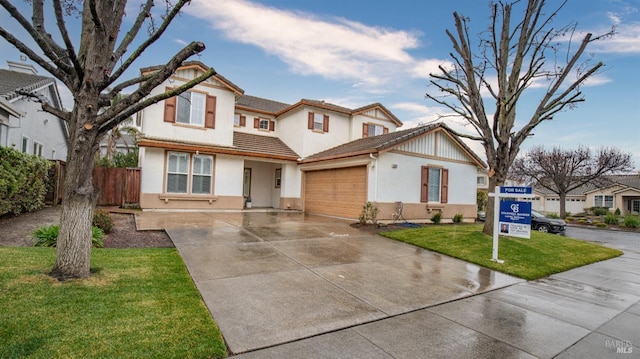 view of front facade with a garage and a front lawn