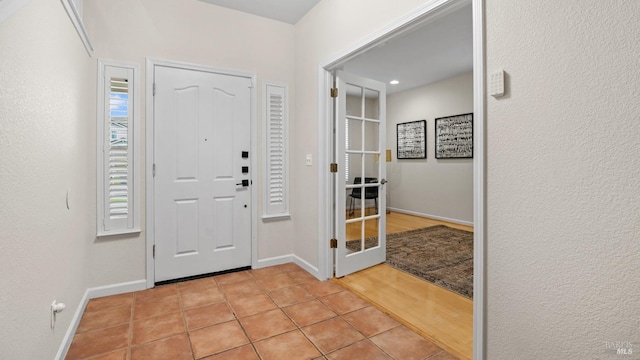 entrance foyer with light tile patterned flooring and plenty of natural light