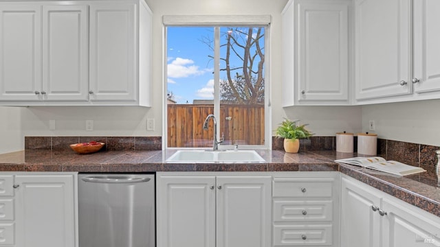 kitchen featuring a sink, tile countertops, and white cabinetry