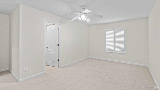 unfurnished room with light colored carpet and ceiling fan