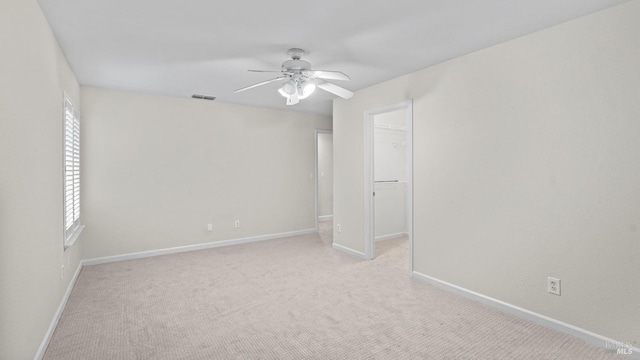 unfurnished bedroom with light colored carpet, baseboards, visible vents, and a spacious closet