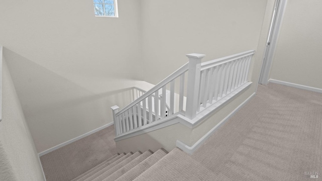 staircase with baseboards and carpet floors