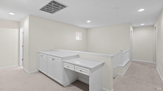 hall featuring recessed lighting, visible vents, and light colored carpet