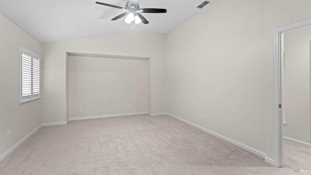 unfurnished room featuring vaulted ceiling, ceiling fan, light carpet, baseboards, and visible vents