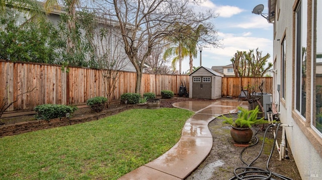 view of yard with a shed, cooling unit, and a patio area