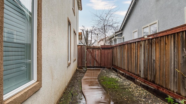 view of property exterior with fence and stucco siding