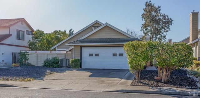 view of front of property with central AC unit and a garage