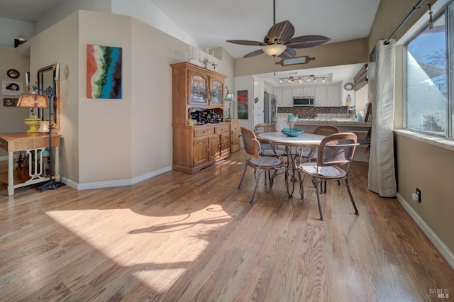 dining space featuring ceiling fan and light hardwood / wood-style floors