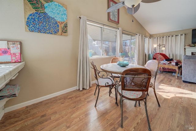 dining room featuring vaulted ceiling, ceiling fan, and light hardwood / wood-style floors