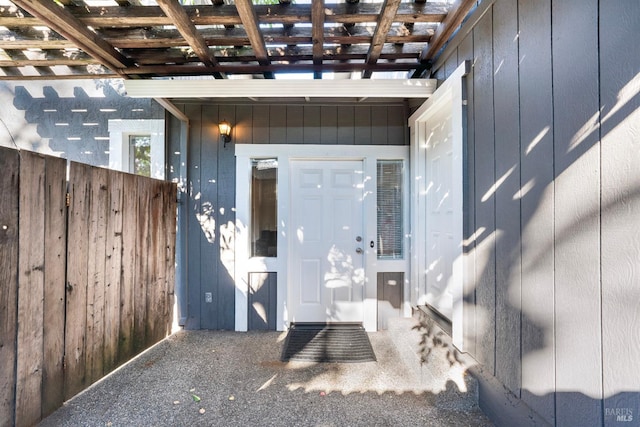 entrance to property featuring a pergola