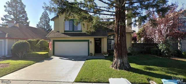 traditional-style house featuring a garage, driveway, a front yard, and stucco siding