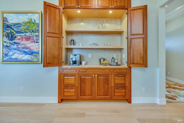 bar featuring light hardwood / wood-style flooring