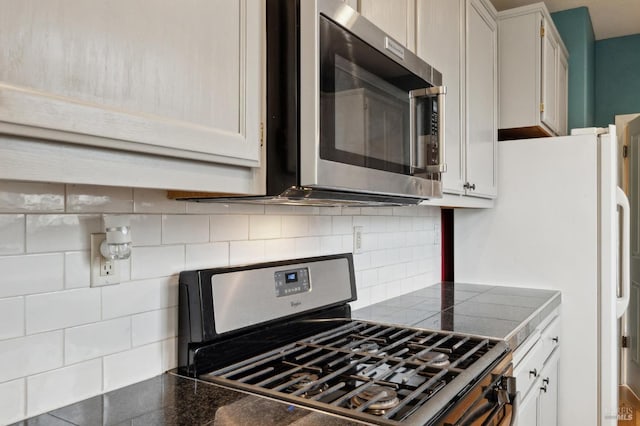 kitchen with white cabinetry, decorative backsplash, and appliances with stainless steel finishes