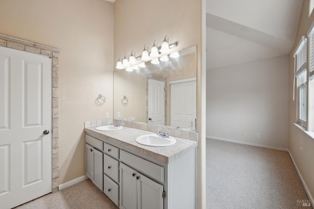 bathroom featuring lofted ceiling and vanity