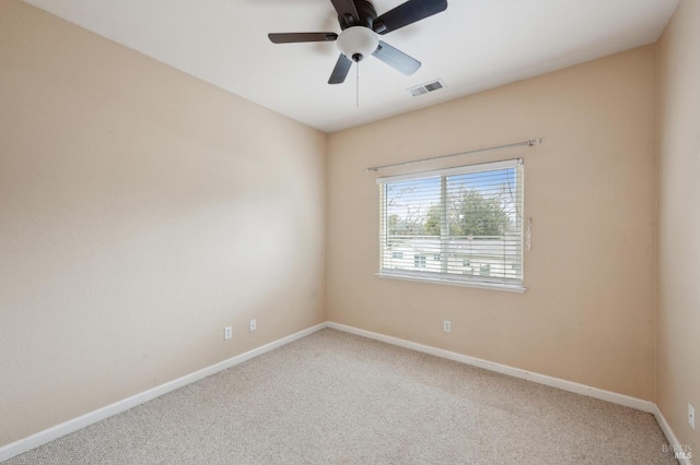 carpeted spare room featuring ceiling fan