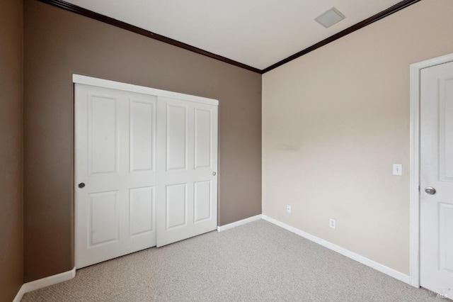 unfurnished bedroom with crown molding and carpet